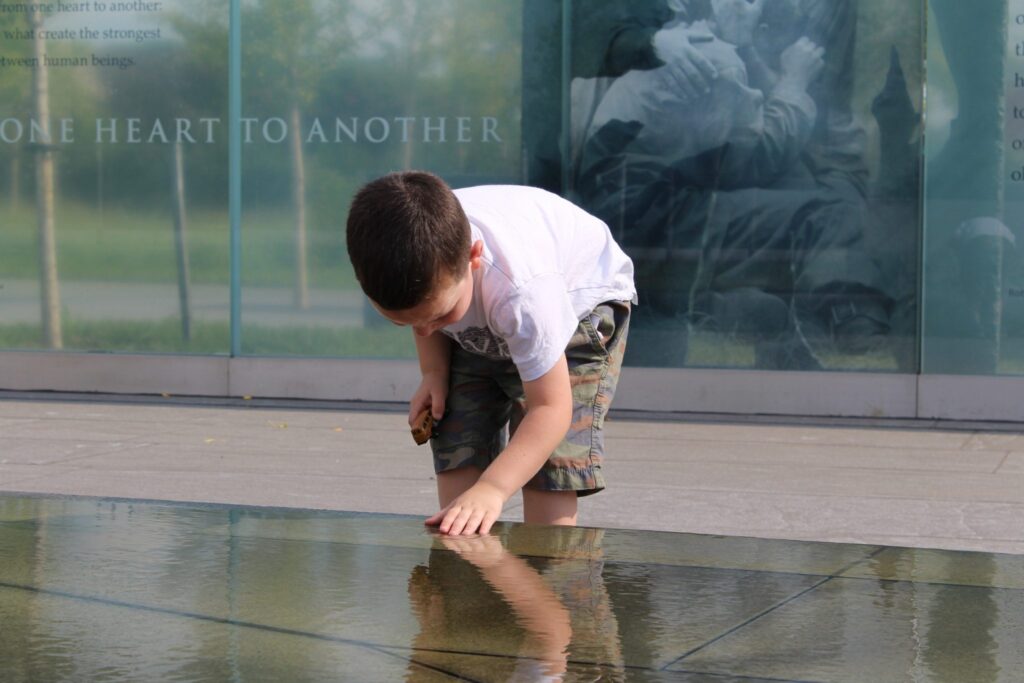 an image of a boy at a memorial