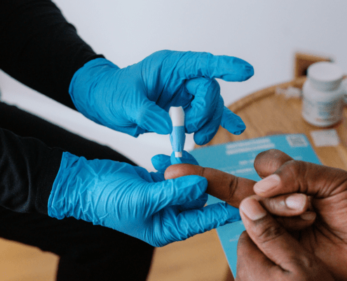 Image of medical professional's hands doing a finger test on a patient