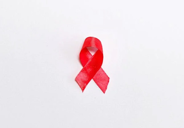 Red ribbon sitting on a white background for World AIDS Day