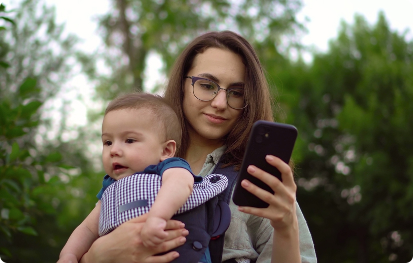 Woman with Baby looking at phone