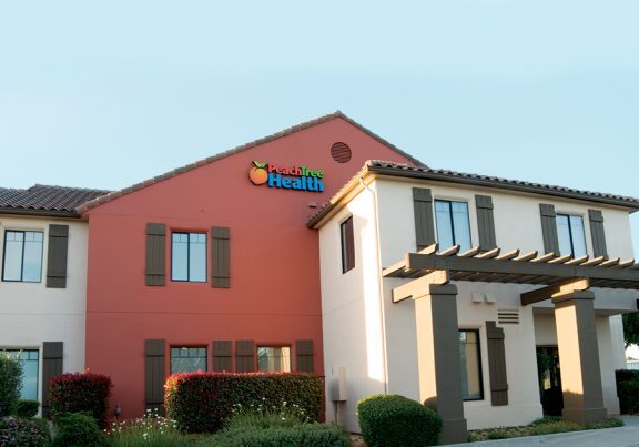 front view of peach tree building