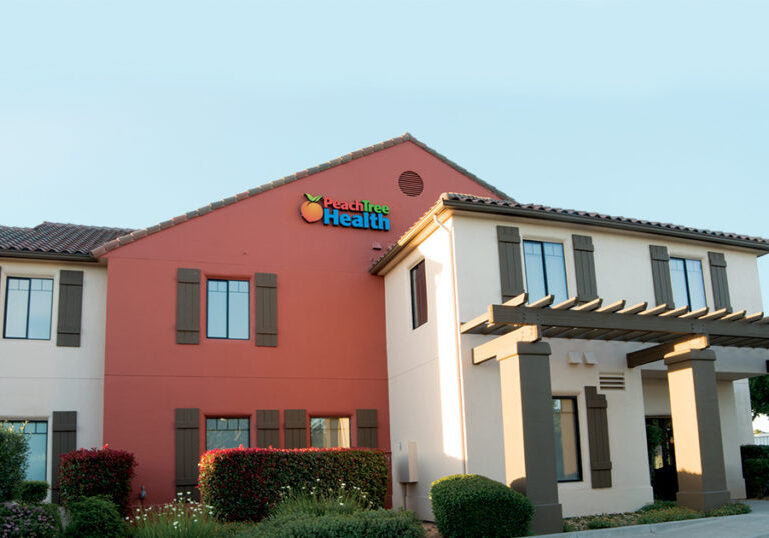 front view of peach tree building