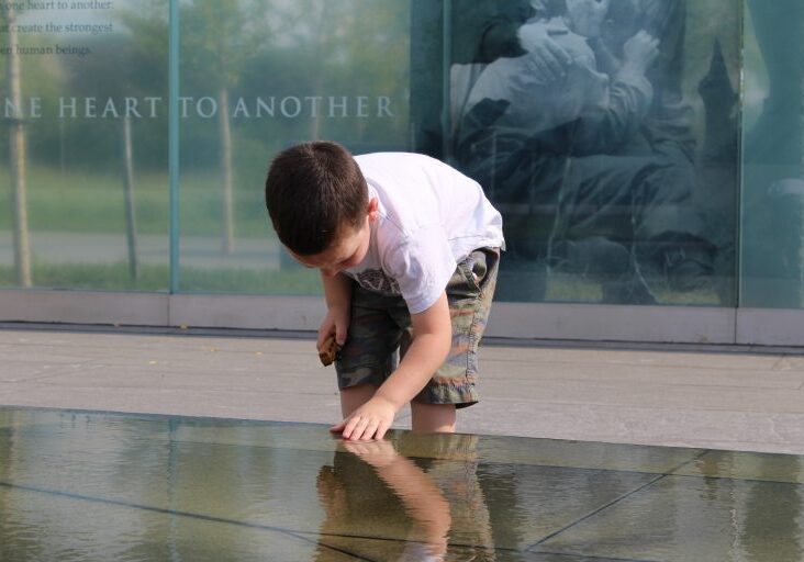 an image of a boy at a memorial