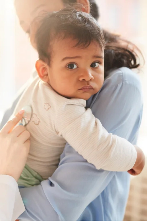 Parent holding a young child