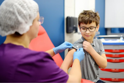 Nurse preparing a child for a shot